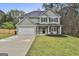 Charming two-story home with a well-maintained lawn and attached two-car garage at 205 Valley View Dr, Tyrone, GA 30290