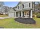 Inviting covered porch with seating, stylish door, black shutters and manicured landscaping at 205 Valley View Dr, Tyrone, GA 30290