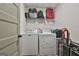 Laundry room with washer, dryer, storage shelf, and modern flooring at 205 Valley View Dr, Tyrone, GA 30290