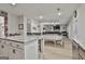 Open-concept living area with island, breakfast bar, and view of the fireplace and living room at 205 Valley View Dr, Tyrone, GA 30290