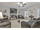 Spacious living room with a stone fireplace, gray sofas, and a ceiling fan at 205 Valley View Dr, Tyrone, GA 30290