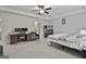 Spacious main bedroom with desk, ceiling fan, and decorative tray ceiling at 205 Valley View Dr, Tyrone, GA 30290