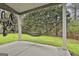 View of covered patio with hanging hammock and bike rack with a green lawn and mature trees at 205 Valley View Dr, Tyrone, GA 30290