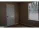 An interior view of a bedroom showing a window and door at 61 Scoby Ct, Jonesboro, GA 30238