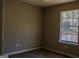 Interior shot of a bedroom showcasing a window and light-colored walls at 61 Scoby Ct, Jonesboro, GA 30238
