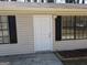 The exterior front door of this home features dual windows and a light fixture at 61 Scoby Ct, Jonesboro, GA 30238
