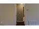 An interior view of a hallway with the entry to a bathroom at the end at 61 Scoby Ct, Jonesboro, GA 30238