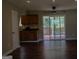 Living room features dark wood floors and sliding glass doors to the deck at 61 Scoby Ct, Jonesboro, GA 30238