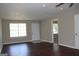 Bright living room with dark floors, windows, and access to another room at 61 Scoby Ct, Jonesboro, GA 30238