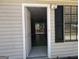 An open door to a home that opens into the living room and sliding glass doors to the back deck at 61 Scoby Ct, Jonesboro, GA 30238