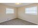 Cozy bedroom with soft carpeting, two bright windows, and neutral walls offering a calming retreat at 3465 Tulip Dr, Decatur, GA 30032