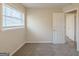 Bright bedroom with neutral walls, new carpet, and natural light from the window at 3465 Tulip Dr, Decatur, GA 30032