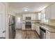 Well-equipped kitchen with stainless steel appliances, granite countertops, modern white cabinetry and hardwood floors at 3465 Tulip Dr, Decatur, GA 30032