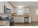 Updated kitchen with granite countertops, white cabinetry, stainless steel appliances, and hardwood floors at 3465 Tulip Dr, Decatur, GA 30032