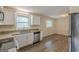 Modern kitchen with stainless steel appliances, granite countertops, white cabinets, and hardwood floors at 3465 Tulip Dr, Decatur, GA 30032