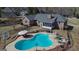 Aerial view of the home, backyard, pool, patio, outdoor seating, and mature trees at 809 Mcbean Ct, Mcdonough, GA 30252