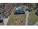Aerial view of home showcasing backyard pool, fenced yard, mature trees, and extended driveway at 809 Mcbean Ct, Mcdonough, GA 30252