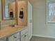Bright bathroom featuring a vanity with a sink, a cabinet, and a window at 809 Mcbean Ct, Mcdonough, GA 30252