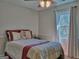 Cozy bedroom featuring a ceiling fan, a window, and neutral colored walls at 809 Mcbean Ct, Mcdonough, GA 30252