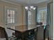 Formal dining room with seating for six, chandelier, and views of outdoor pool at 809 Mcbean Ct, Mcdonough, GA 30252