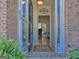 Inviting front entrance featuring brick detail, glass storm door, and neutral interior color palette at 809 Mcbean Ct, Mcdonough, GA 30252