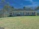 Charming brick home featuring a well-maintained lawn, arched windows and classic black shutters at 809 Mcbean Ct, Mcdonough, GA 30252