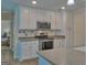 Well-lit kitchen featuring white cabinets, stainless steel appliances, and an updated countertop at 809 Mcbean Ct, Mcdonough, GA 30252