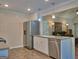 Modern kitchen with stainless steel appliances, tile floors, and an open layout to the living room at 809 Mcbean Ct, Mcdonough, GA 30252