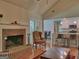Open-concept living room featuring a brick fireplace and seamless transition to the kitchen at 809 Mcbean Ct, Mcdonough, GA 30252