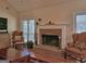 Comfortable living room with a brick fireplace, vaulted ceiling, and classic furnishings at 809 Mcbean Ct, Mcdonough, GA 30252