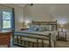 Comfortable main bedroom with ample natural light, a vaulted ceiling, and a decorative metal bed frame at 809 Mcbean Ct, Mcdonough, GA 30252