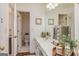Well-lit bathroom with a decorative vanity, framed art, and neutral flooring at 265 Ridgewood Dr, Fayetteville, GA 30215