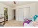 Bright bedroom with bed and colorful pillows with a view of a closet and doorway at 265 Ridgewood Dr, Fayetteville, GA 30215