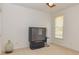 Bedroom features a large television, neutral carpet, and natural light from the window at 265 Ridgewood Dr, Fayetteville, GA 30215