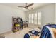 Bright bedroom features a ceiling fan, a window, and fun decor at 265 Ridgewood Dr, Fayetteville, GA 30215