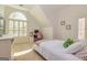 Bright bedroom with arched window, TV, neutral carpet, and white furniture at 265 Ridgewood Dr, Fayetteville, GA 30215