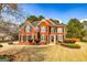 Charming two-story red brick home with a beautifully landscaped front yard at 265 Ridgewood Dr, Fayetteville, GA 30215