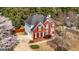 Beautiful two-story red brick and gray sided home with a well-manicured lawn and mature trees at 265 Ridgewood Dr, Fayetteville, GA 30215