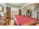 Game room featuring a red felt pool table, wood floors, natural light and access to the main living areas at 265 Ridgewood Dr, Fayetteville, GA 30215