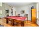Bright game room featuring a red felt pool table, hardwood floors, and elegant decor at 265 Ridgewood Dr, Fayetteville, GA 30215