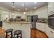 Bright kitchen features granite countertops, stainless steel appliances, and a breakfast bar with seating at 265 Ridgewood Dr, Fayetteville, GA 30215