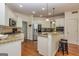 Well-lit kitchen with stainless steel appliances, granite countertops, and breakfast bar with pendant lighting at 265 Ridgewood Dr, Fayetteville, GA 30215