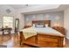 Bright main bedroom boasts hardwood floors, a large window, and decorative wall hangings at 265 Ridgewood Dr, Fayetteville, GA 30215