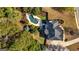 Aerial view of a backyard oasis with a custom-shaped pool, lush landscaping, and a cozy gazebo at 265 Ridgewood Dr, Fayetteville, GA 30215