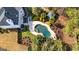 Overhead shot of a luxurious pool area with elegant patio furniture and beautiful greenery, ideal for outdoor living at 265 Ridgewood Dr, Fayetteville, GA 30215