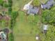 An aerial view of the property showcasing a large lawn and mature trees at 142 Gillson Dr, Mcdonough, GA 30253