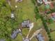 Aerial view of a landscaped home featuring a lush green lawn with mature trees at 142 Gillson Dr, Mcdonough, GA 30253
