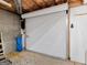 Unfinished basement features an access door, concrete walls, and exposed pipes at 142 Gillson Dr, Mcdonough, GA 30253