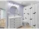Charming bathroom with a white vanity, round mirror, and shower with bat-themed curtain at 142 Gillson Dr, Mcdonough, GA 30253