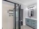 Bathroom featuring a shower with dark framed doors, white walls, and a modern vanity at 142 Gillson Dr, Mcdonough, GA 30253